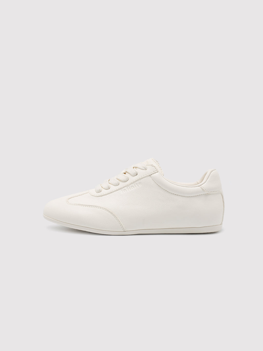 Side view of women's white leather low-profile sneakers
